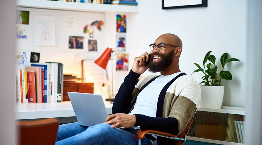 Man sitting with a laptop in an office