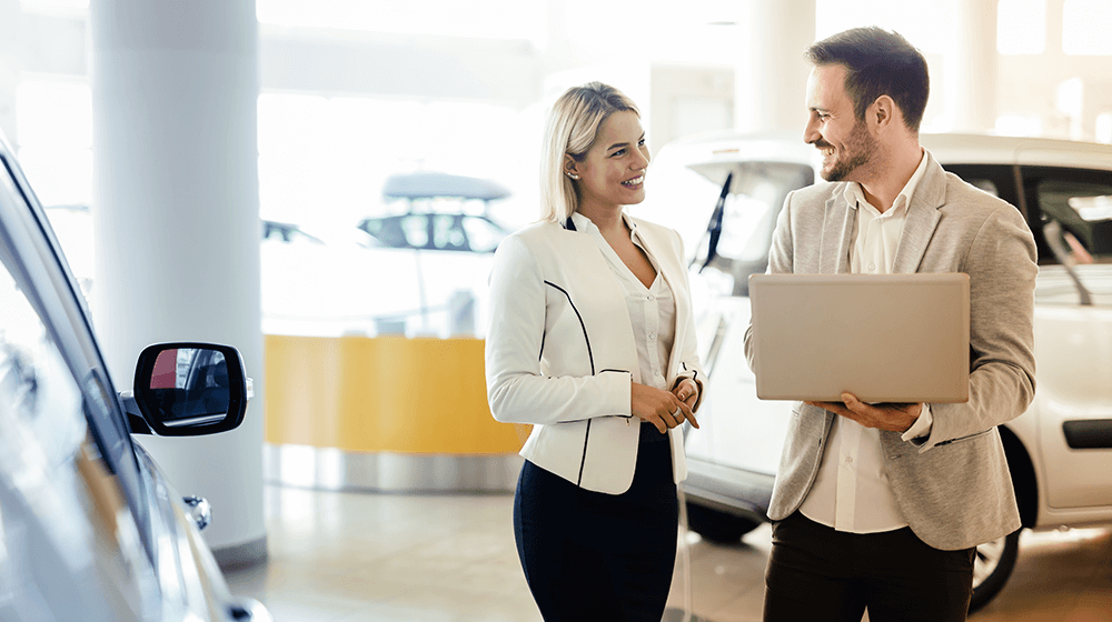 Car salesperson speaking to a customer