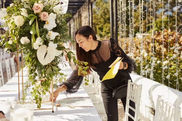 Wedding planner arranging flowers